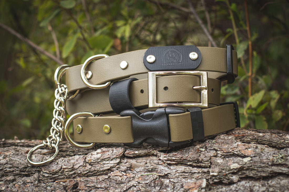 Backwoods Dog waterproof BioThane vegan leather dog collars stacked on a log, 3 collar styles that include buckle, quick-release, and martingale in olive drab colour