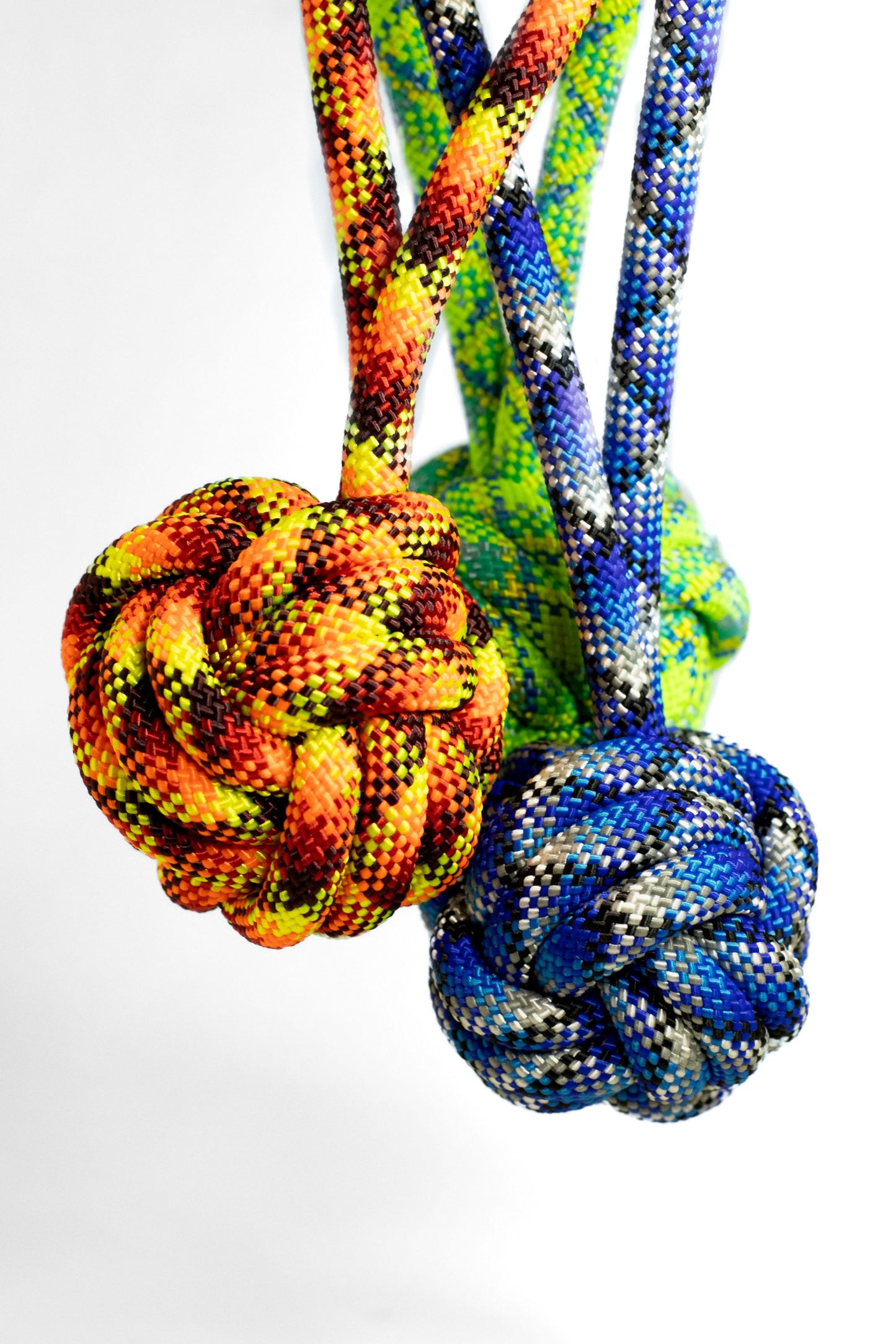 Colorful knotted rope toys on a white background