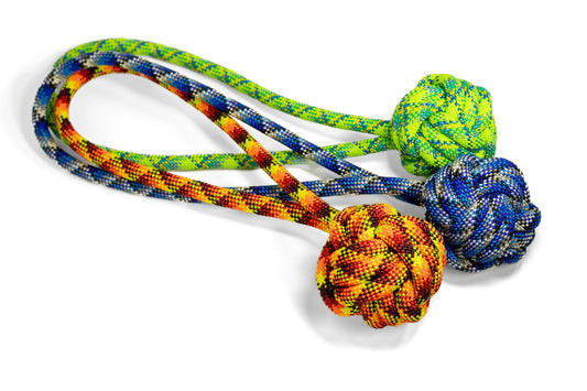 Colorful dog toy with rope and two knotted balls on a white background